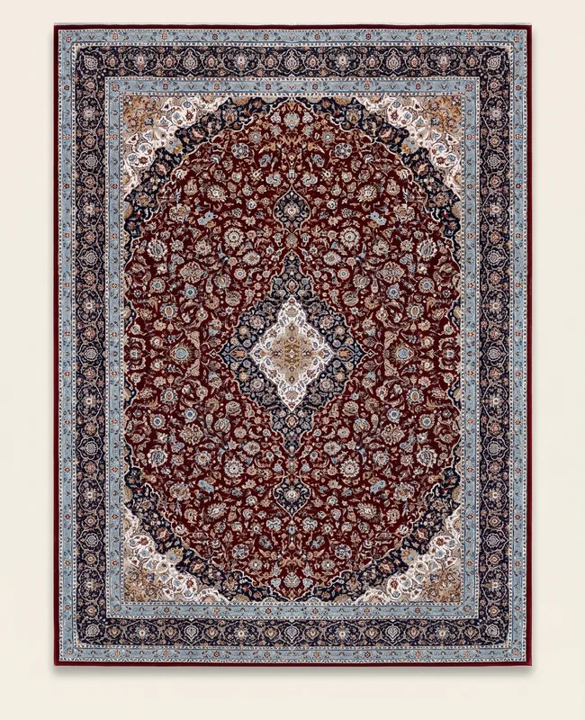 A richly coloured traditional rug with a dense floral pattern and a defined central medallion in deep tones.