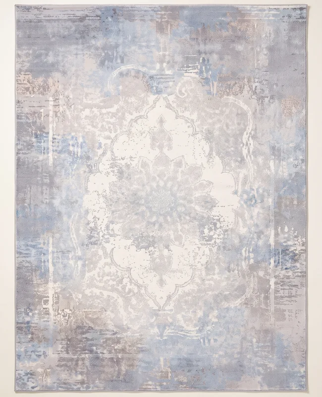 Understated abstract rug with a layered, worn texture and subtle colour variation.