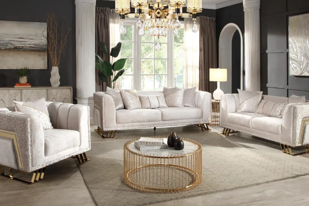 A cream textured sofa set on slim gold-finished legs in a bright lounge.