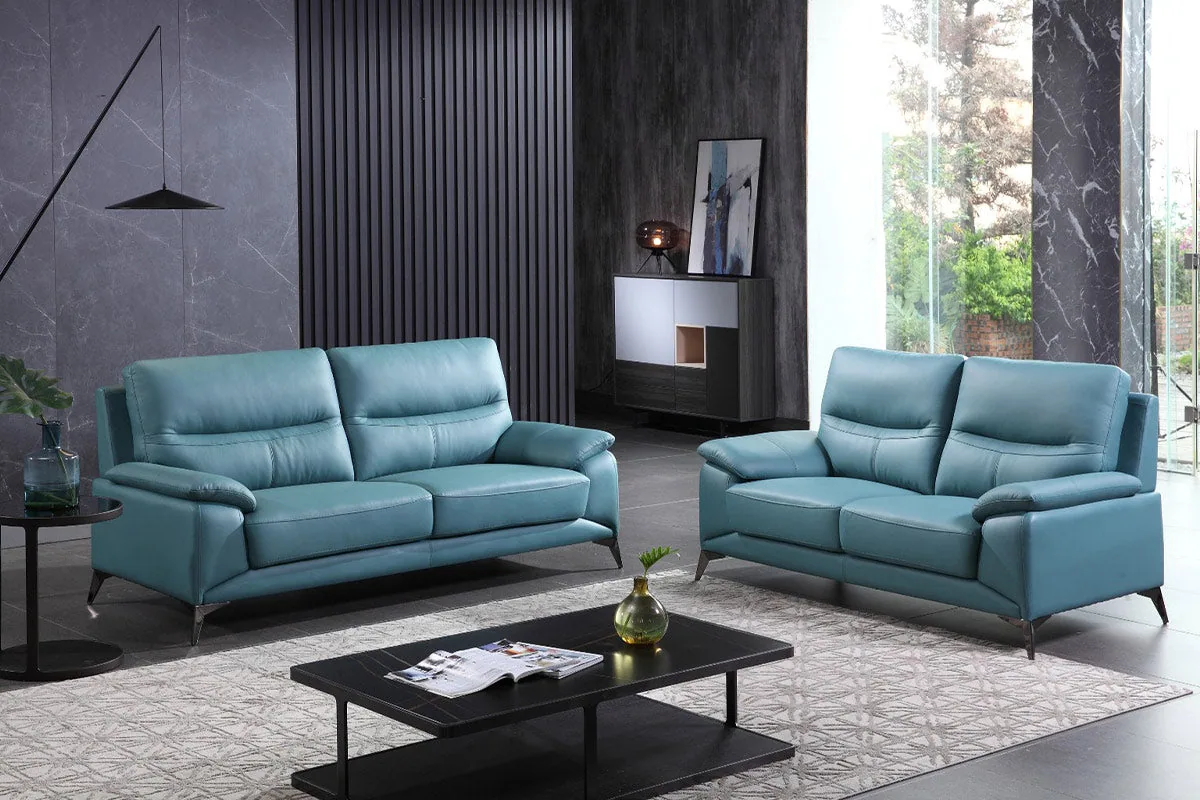 A wide, low modern sofa set with deep seat cushions and slim metal legs.