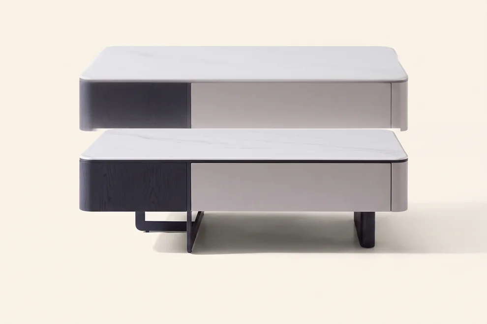 Rectangular marble-topped coffee table on a two-tone base with an off-centre support.